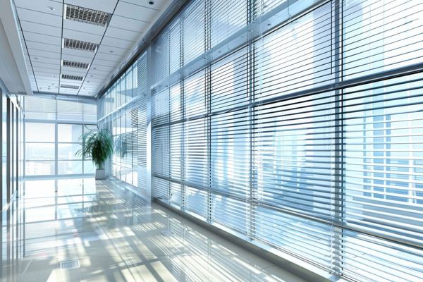Blinds along a bright commercial office corridor window