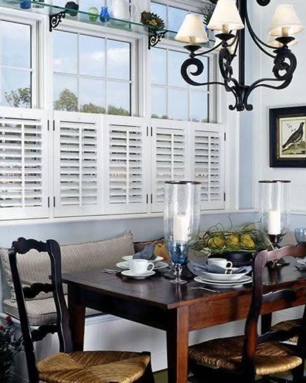 Café-style white shutters across a dining nook window